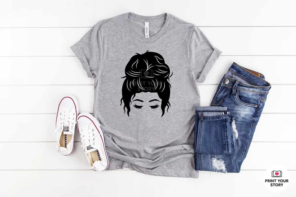 Gray T-shirt with black messy bun face SVG design, styled with jeans and sneakers