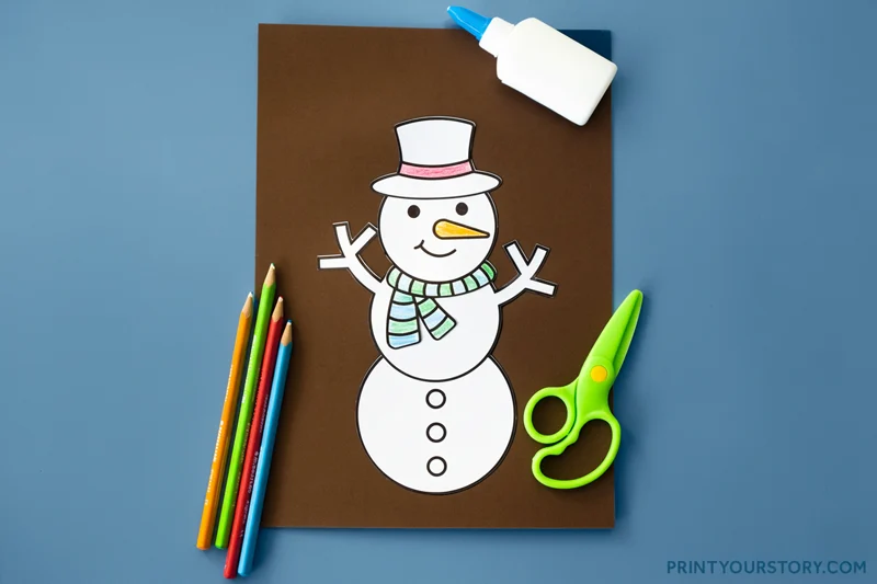 Finished printable snowman coloring craft with colored pencils, glue, and scissors