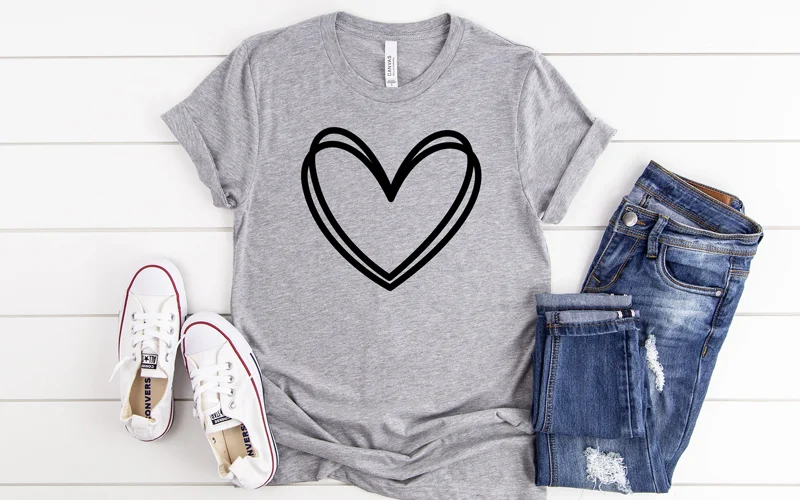 Gray T-shirt with black heart outline SVG design, styled with jeans and white sneakers