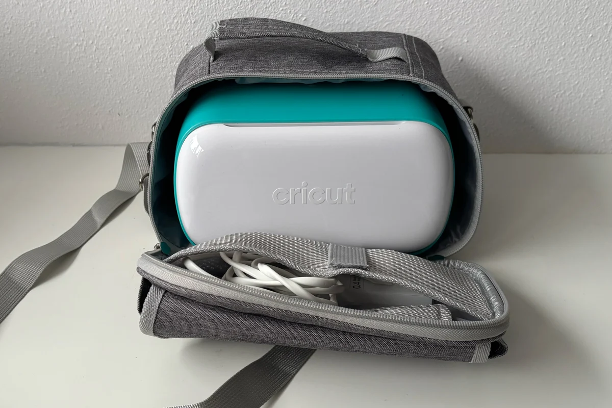 Cricut Joy machine stored inside a gray carrying case for compact craft room organization