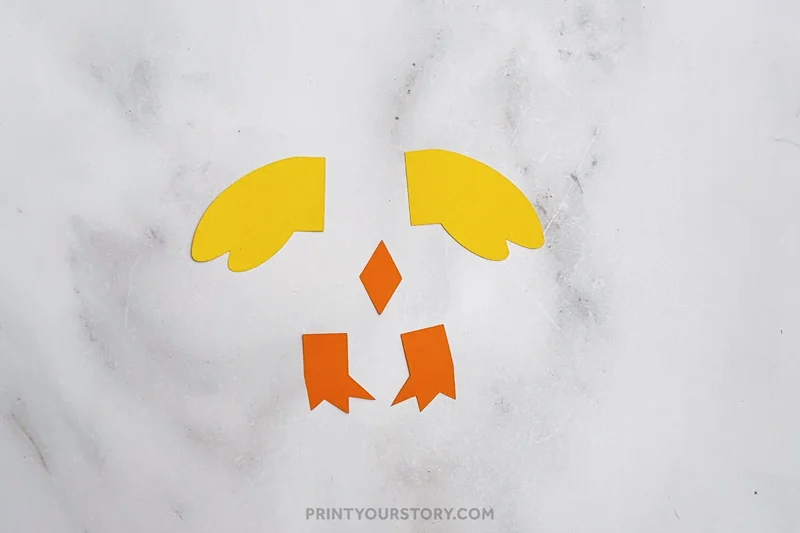 Yellow wings, orange beak, and feet cutouts for a toilet paper roll chick craft