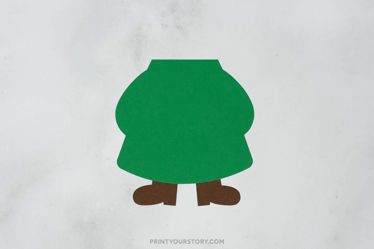 Green paper gnome body with brown feet for a St. Patrick’s Day craft