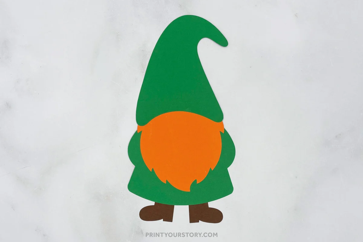 Paper St. Patrick’s Day gnome craft with green hat, green body, orange beard, and brown boots