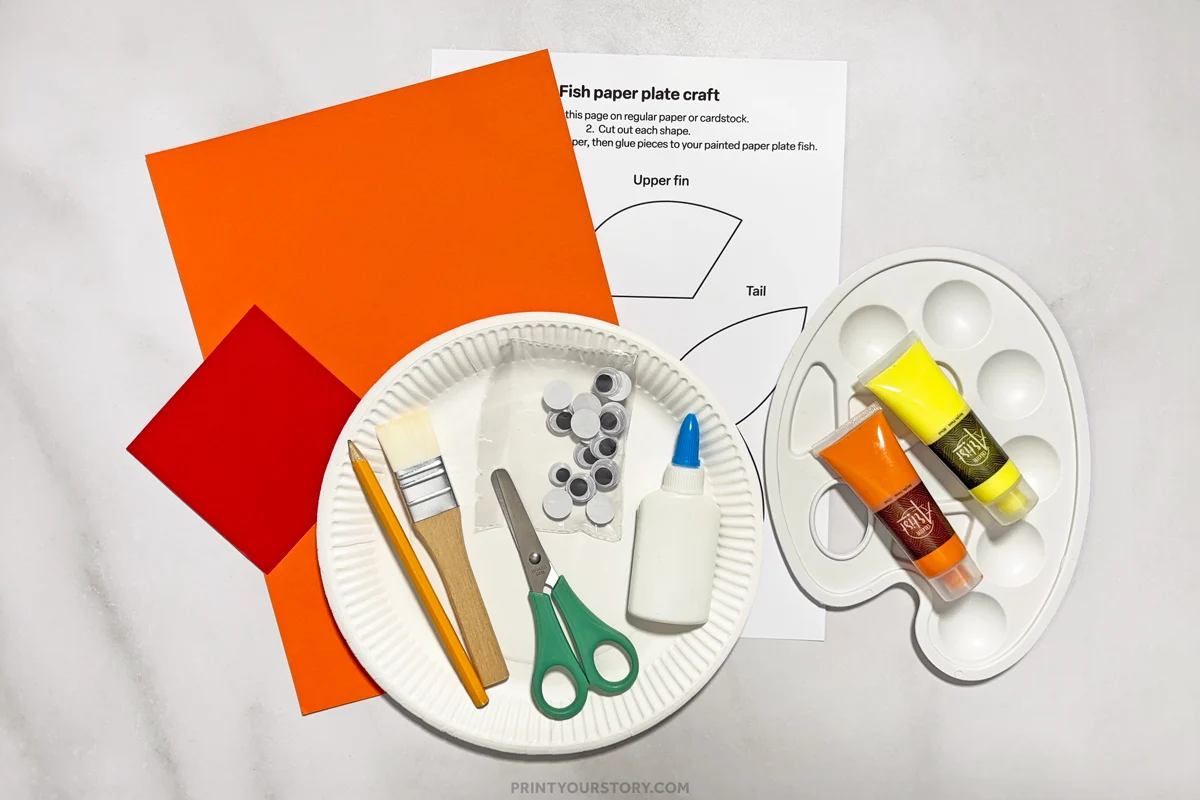 Materials for a paper plate fish craft: paper plates, paint, template, paper, glue, scissors, brush, and googly eyes