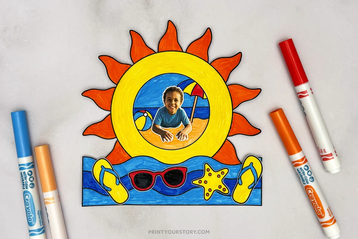 Finished summer photo frame craft featuring a sun-shaped frame, beach scene, child photo, flip-flops, sunglasses, and starfish, displayed with colorful markers on a gray background.