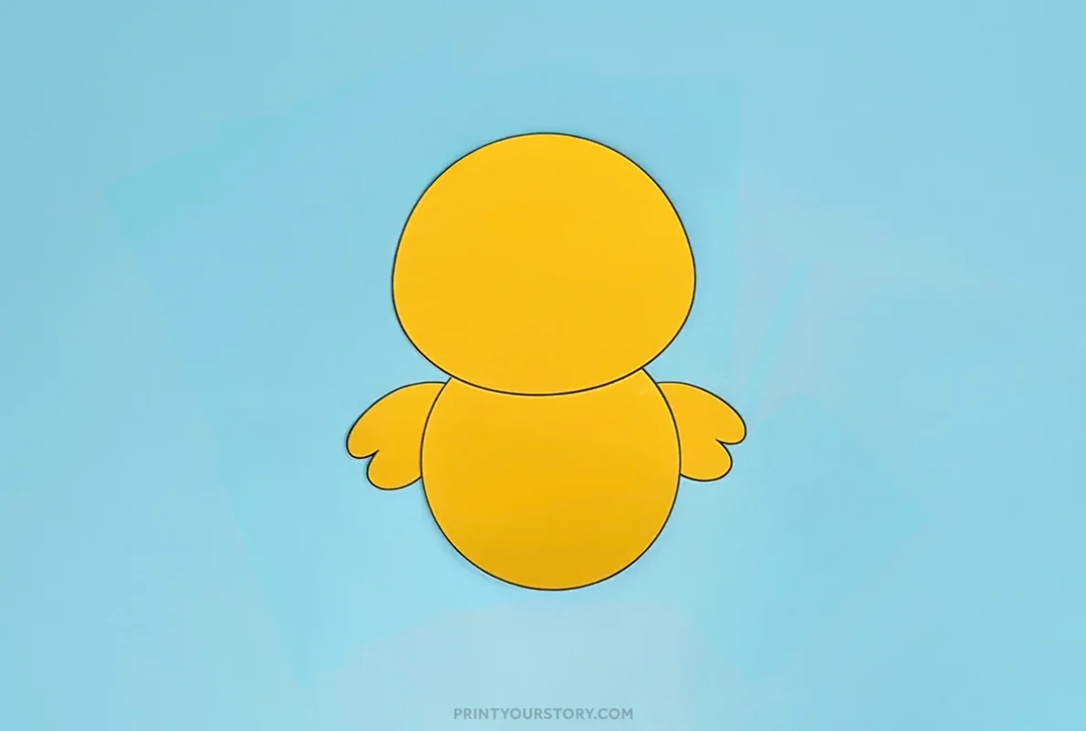 Yellow paper chick body with wings on a blue background