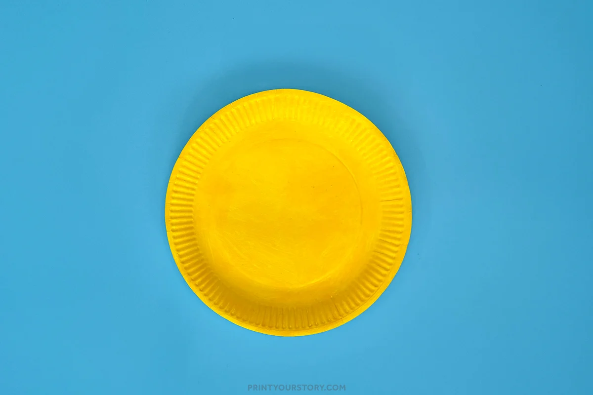 Yellow paper plate on blue background