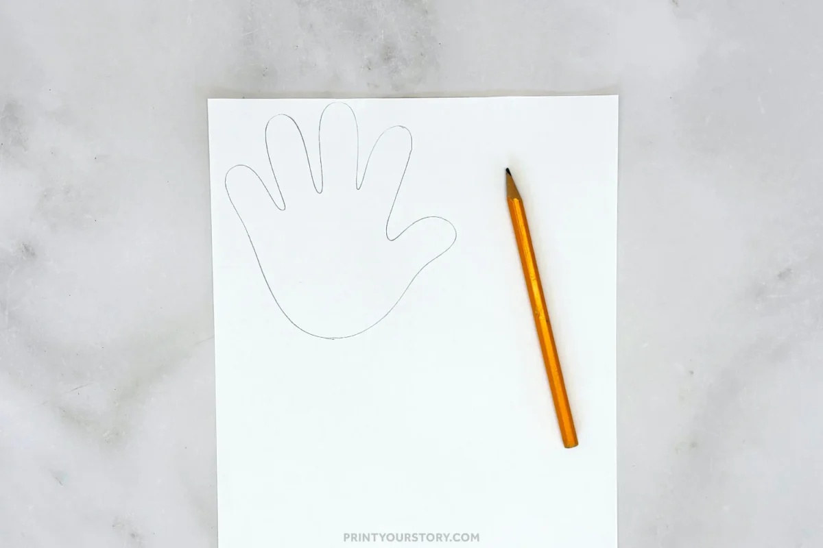 Traced handprint on white paper with a pencil for a bunny craft step