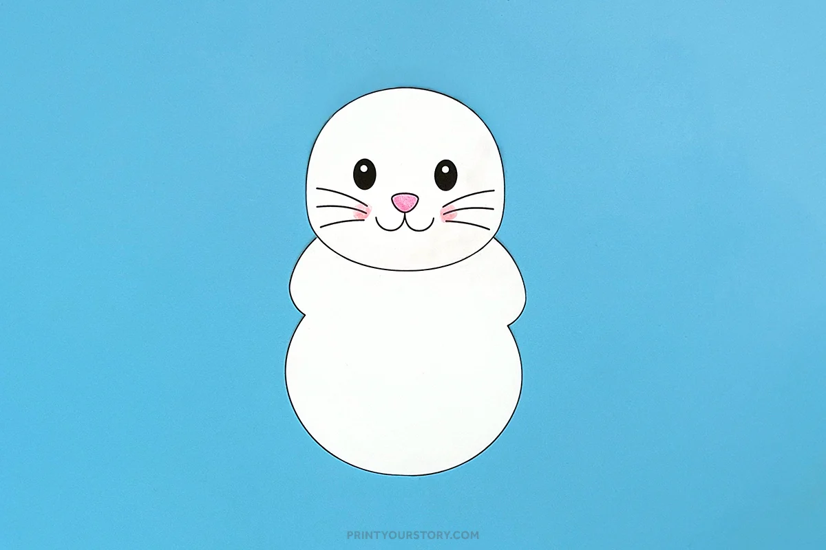 Partly assembled Easter bunny printable craft with a face and body on a blue background
