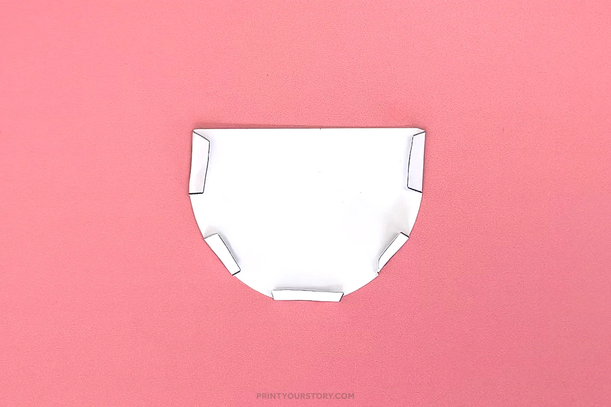 Cut white paper teacup template with folded tabs on a pink background
