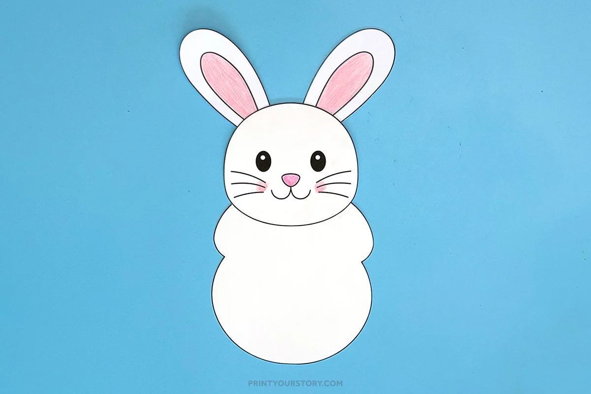 Printable Easter bunny craft with ears and face assembled on blue paper