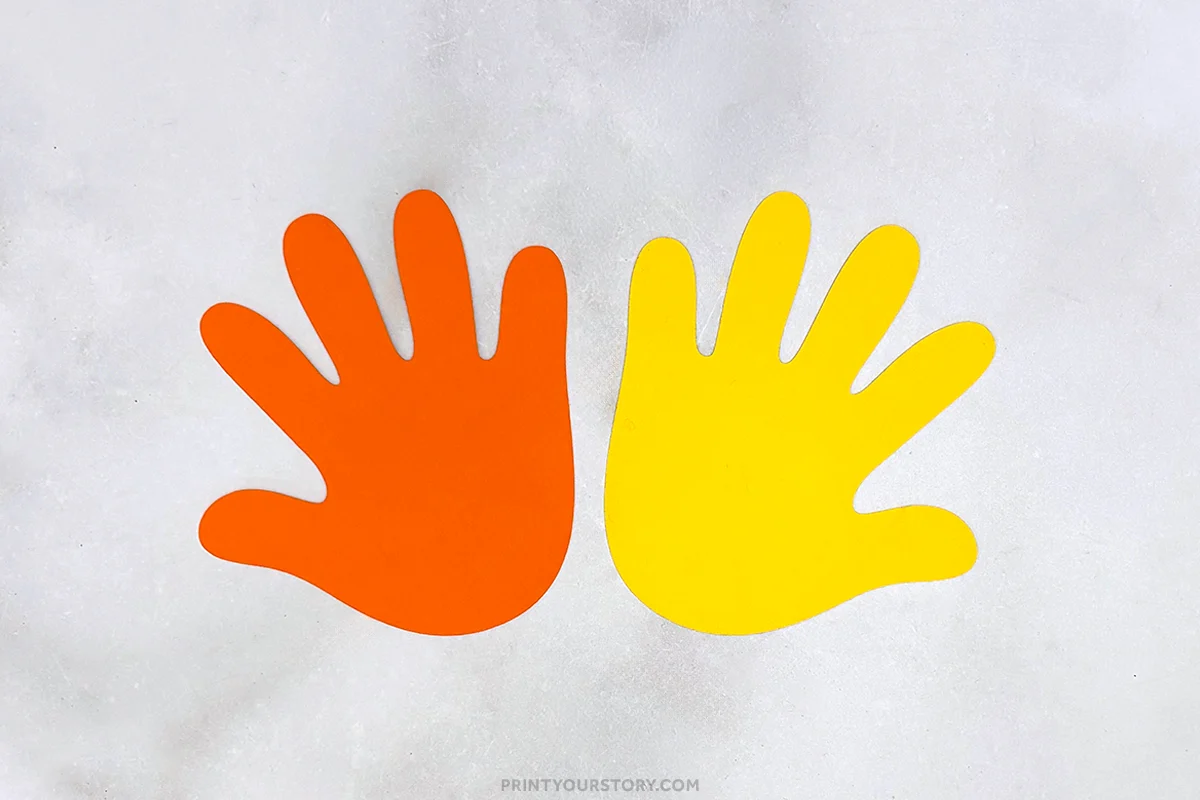 Orange and yellow paper handprint cutouts for a rocket handprint craft