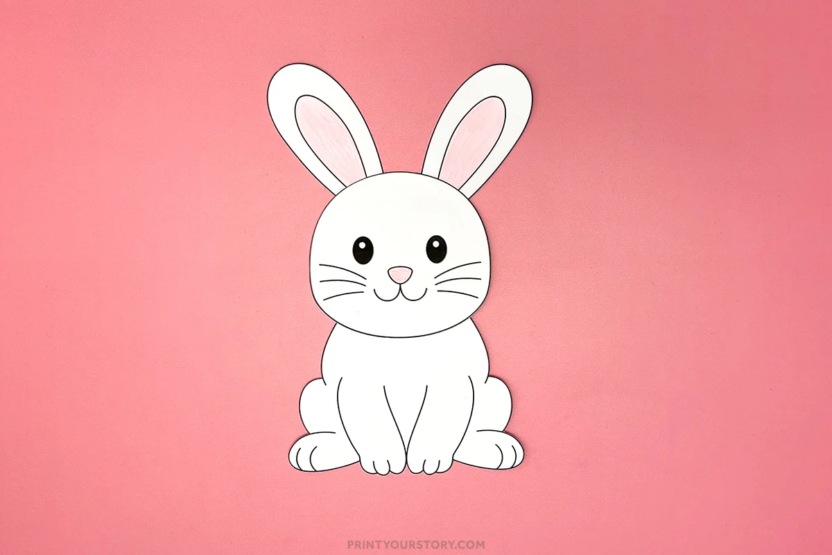 Assembled paper bunny printable craft on a pink background