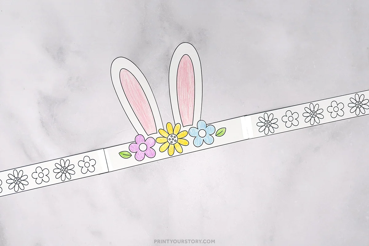 Printable bunny headband craft with colored ears and flowers on a paper band