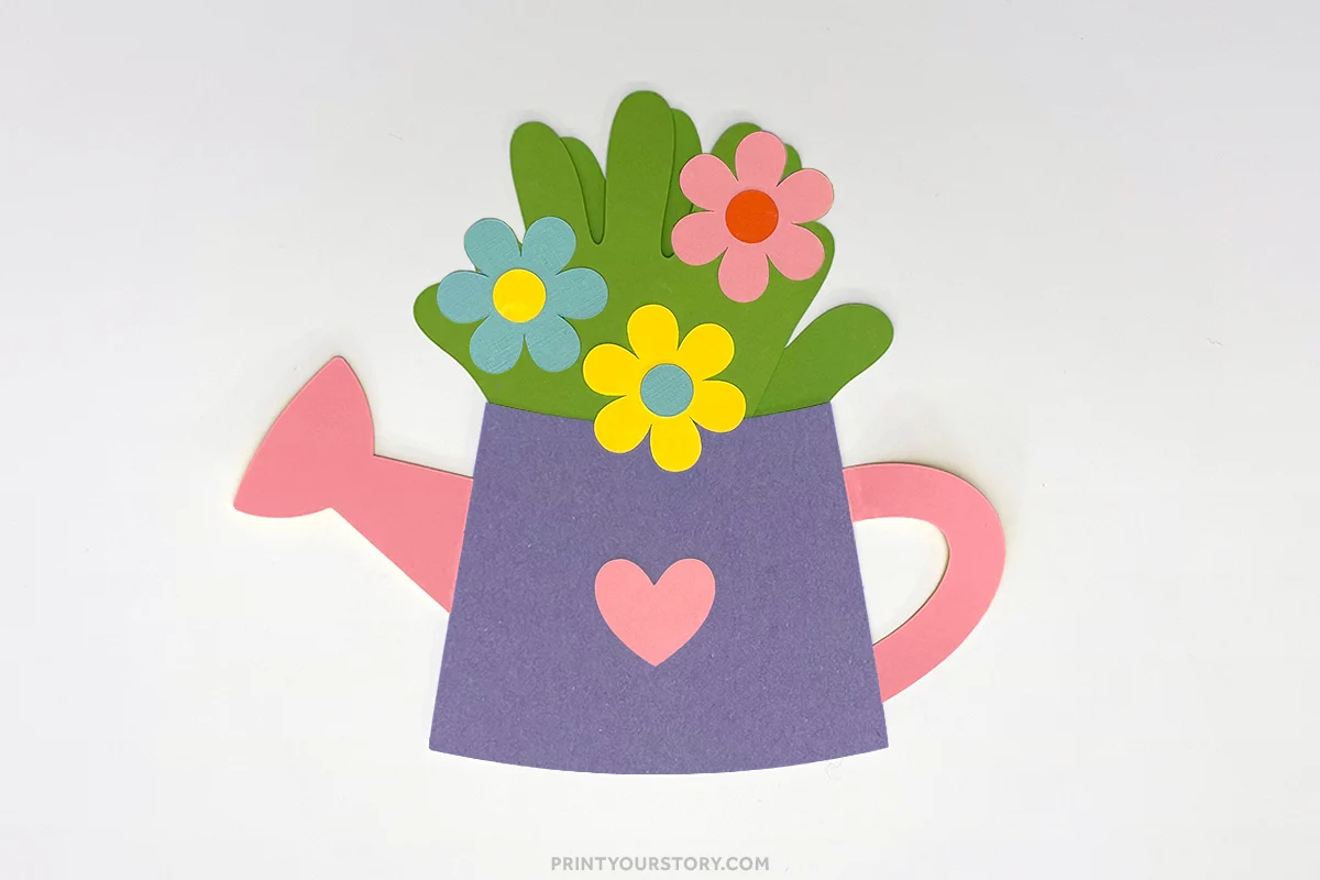 Paper watering can handprint craft with flowers and a heart decoration