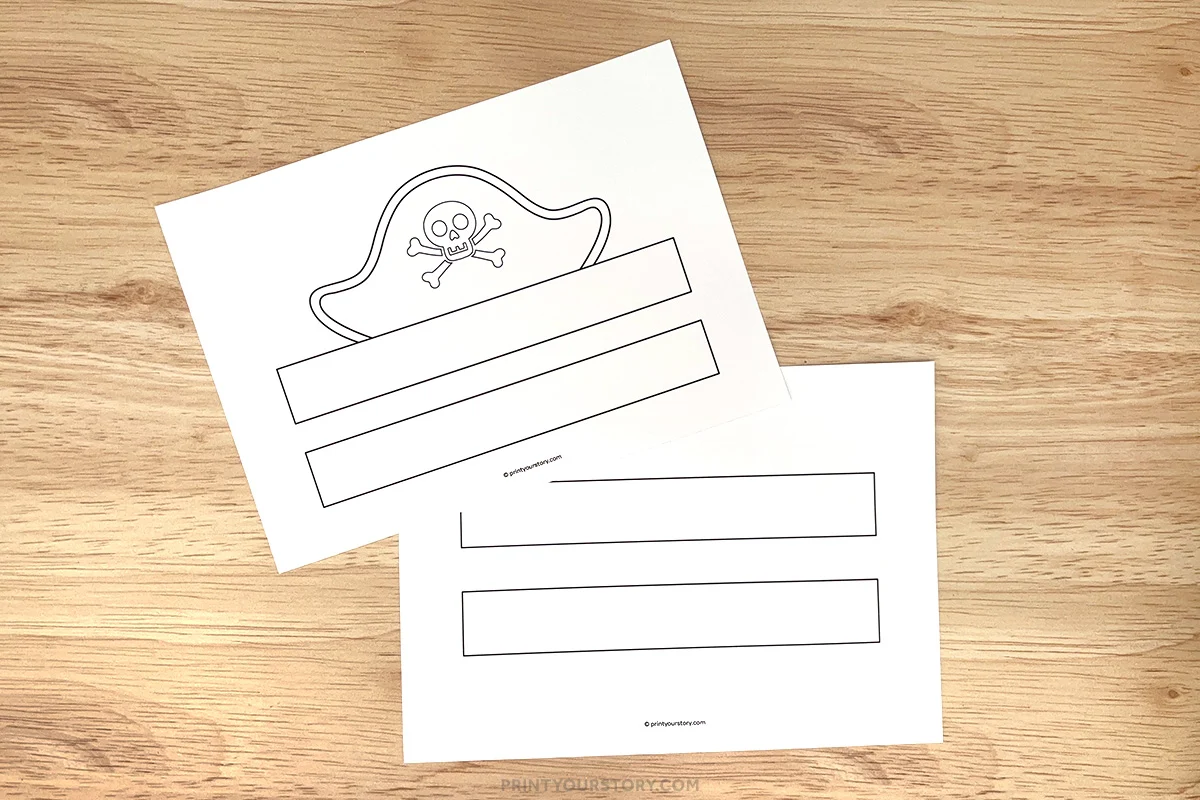 Printable pirate hat template pages with skull hat outline and headband strips on a wooden table
