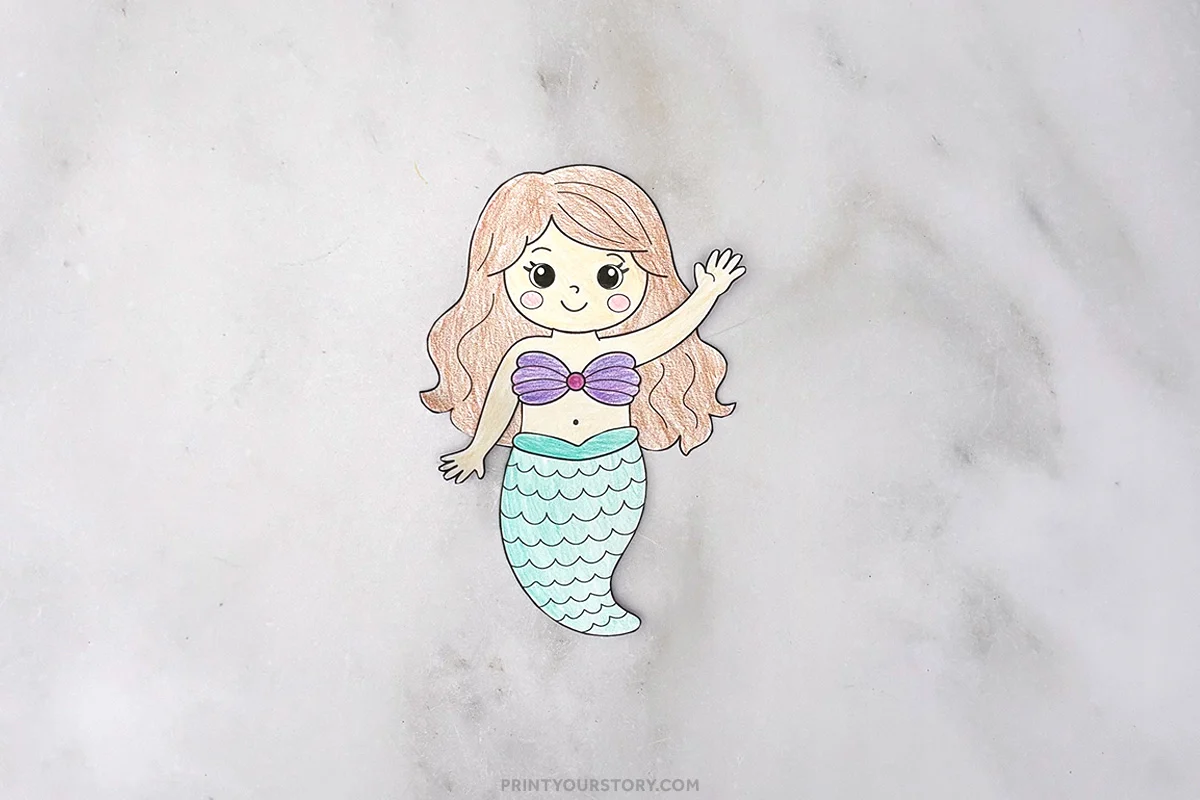 Step of a colored paper mermaid craft with waving arm and turquoise tail