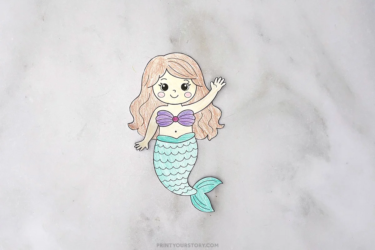 Completed colored paper mermaid craft with purple top and teal tail