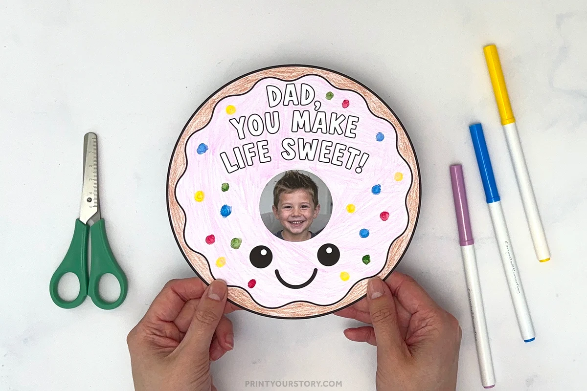 Father’s Day donut craft with child’s photo and “Dad, you make life sweet!” text, markers, and scissors