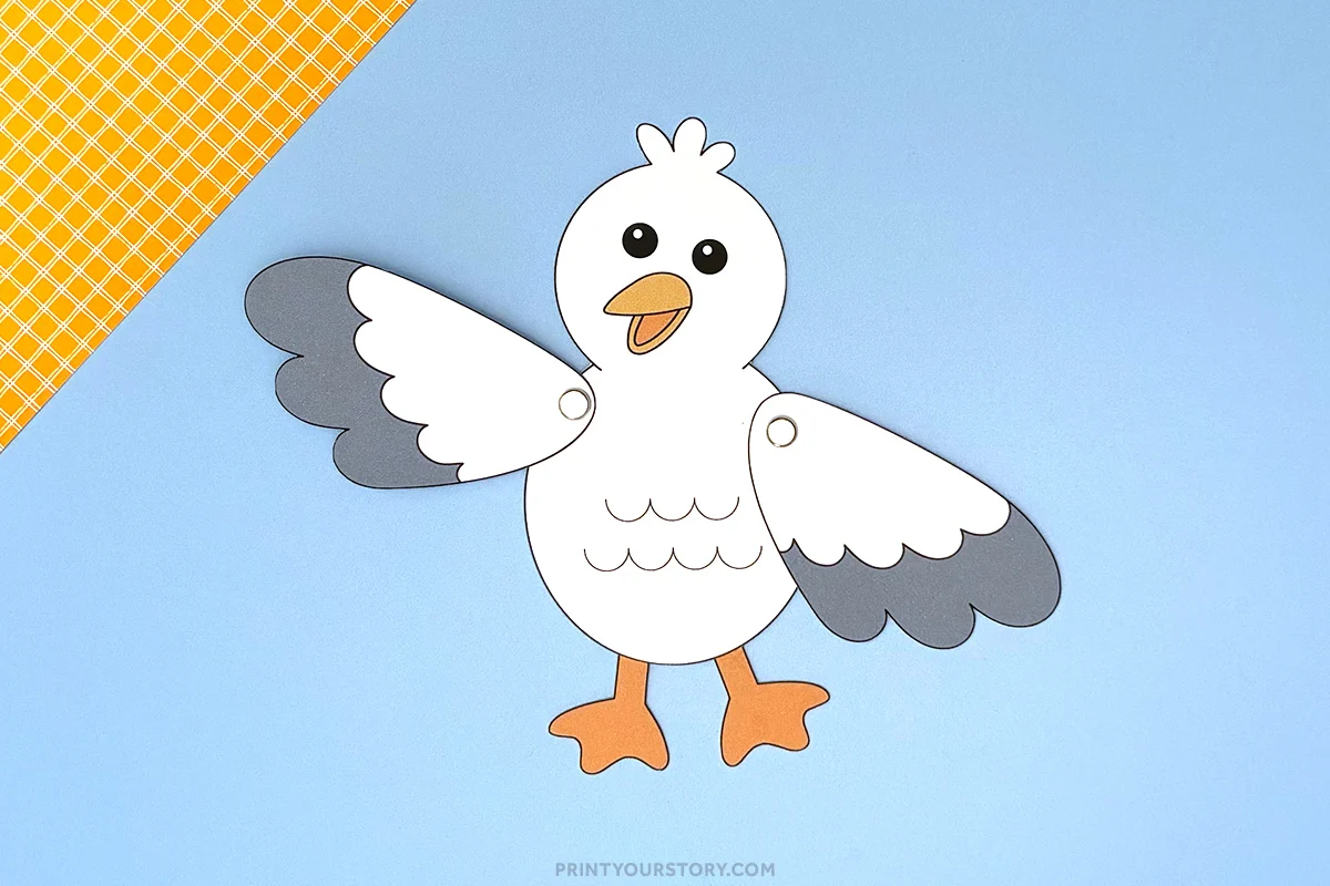 Paper seagull craft with movable wings on a blue background