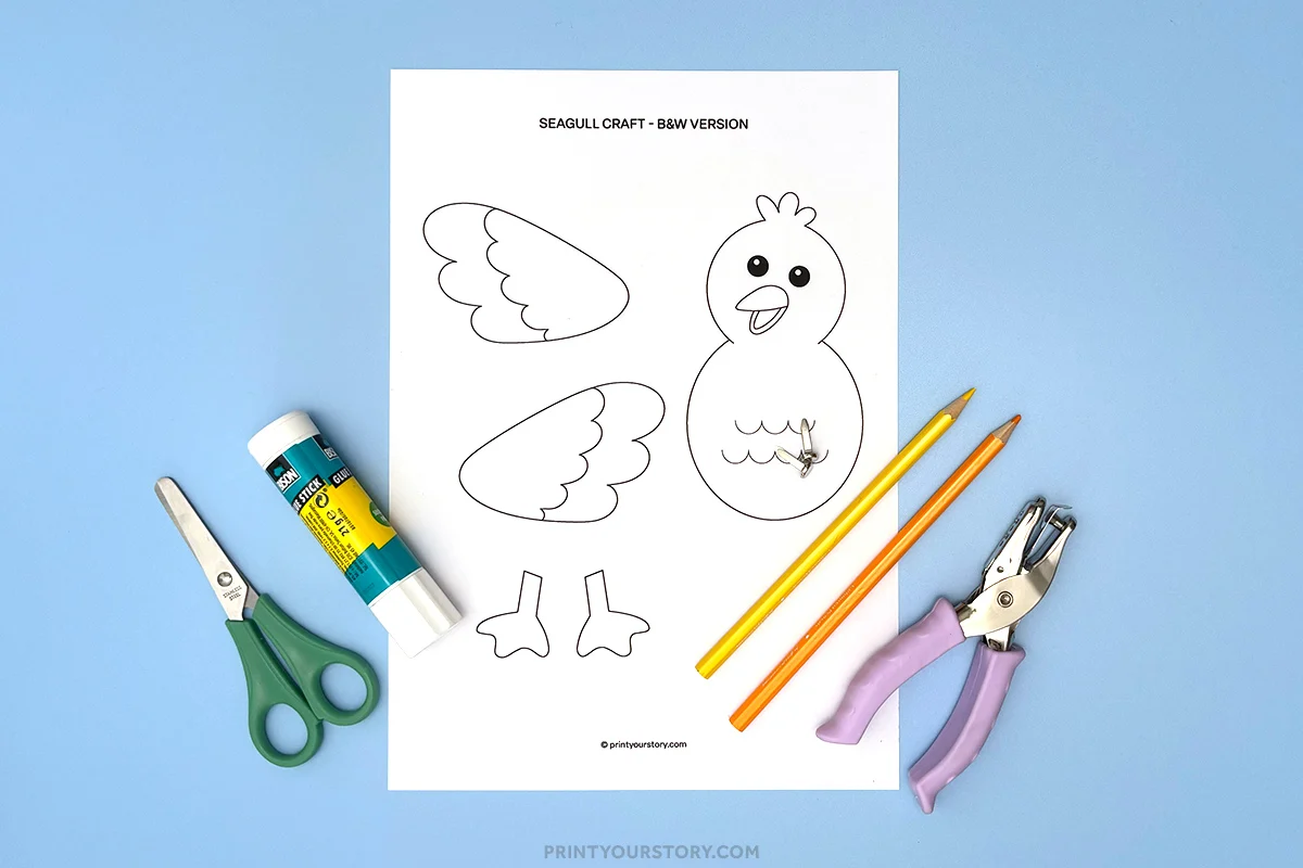 Printable seagull craft template with scissors, glue, colored pencils, and hole punch on a blue background