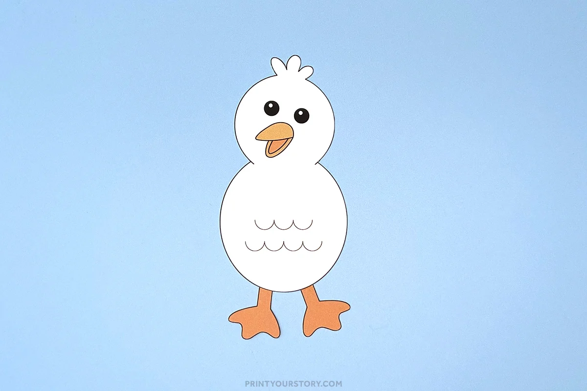 Paper seagull craft with orange beak and feet on a light blue background
