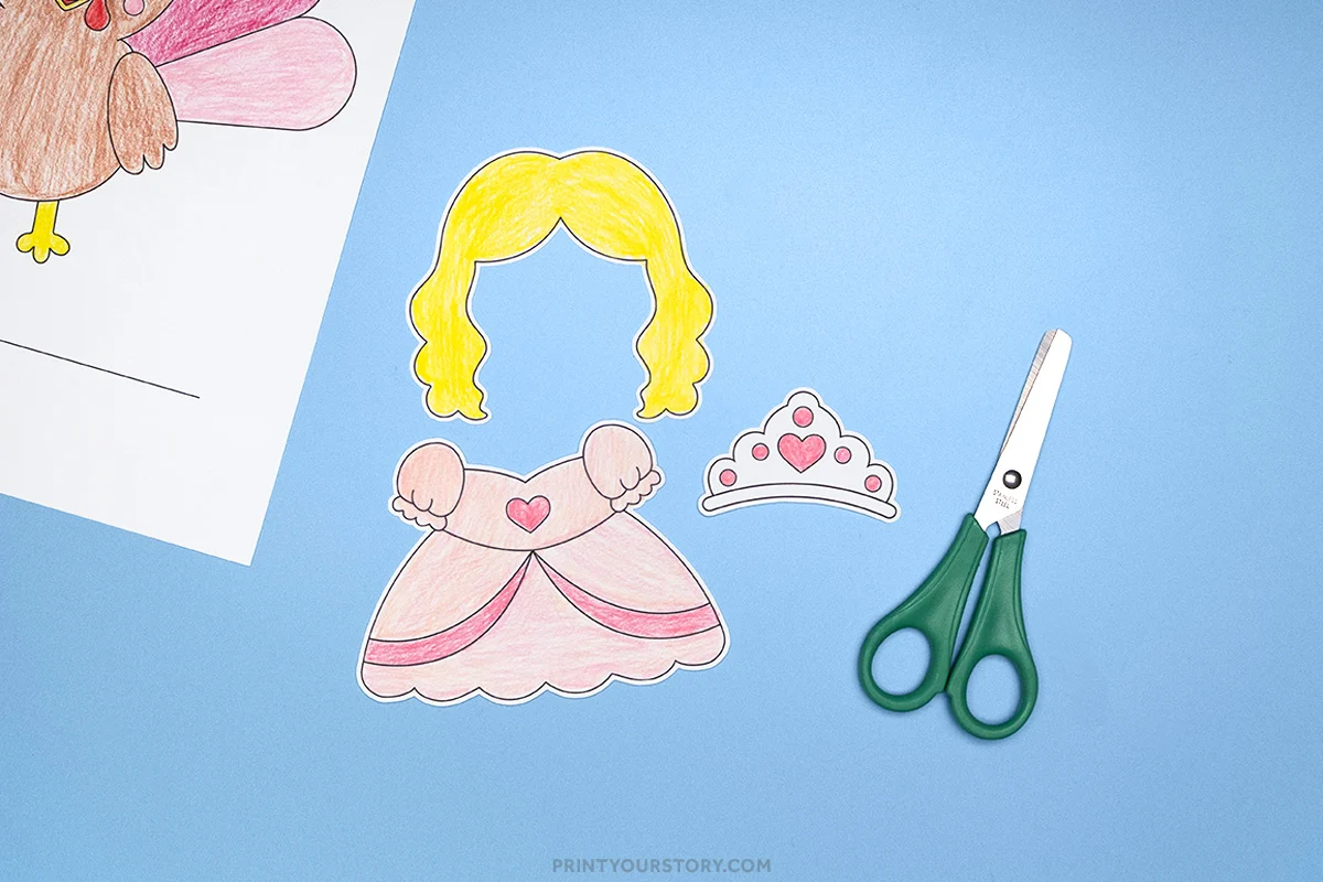 Cut out princess disguise template pieces with yellow hair, pink dress, tiara, and scissors on blue background