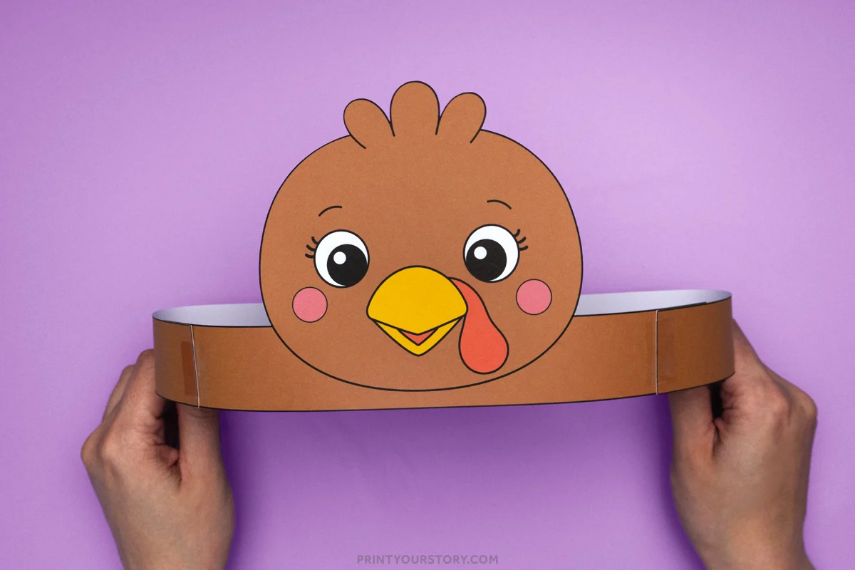 Printable turkey headband craft for kids with a brown turkey face and paper band held in two hands