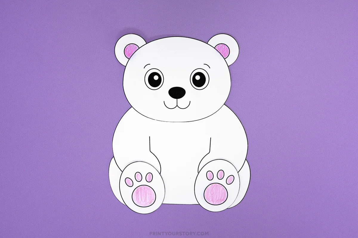 Assembled polar bear craft with pink inner ears and paw pads on a purple background