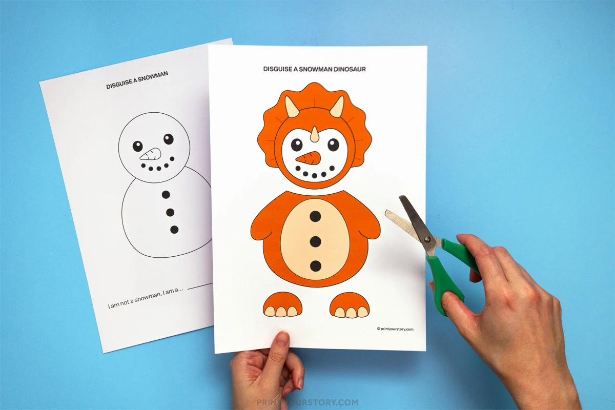 Hands cutting out a printable disguise a snowman dinosaur craft template beside a snowman worksheet