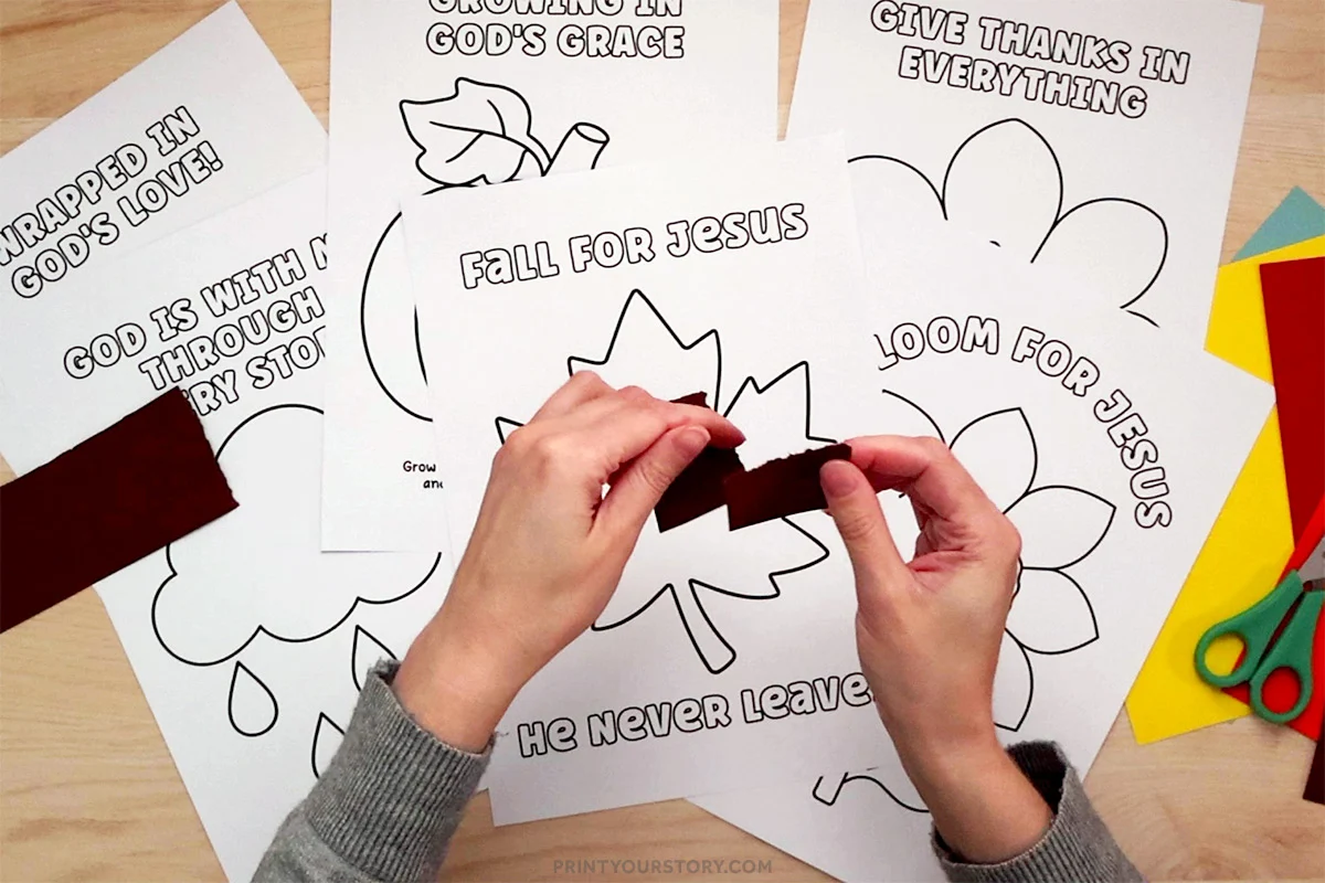 Hands tearing brown paper above Christian fall torn paper craft printables with leaf, flower, and acorn outlines