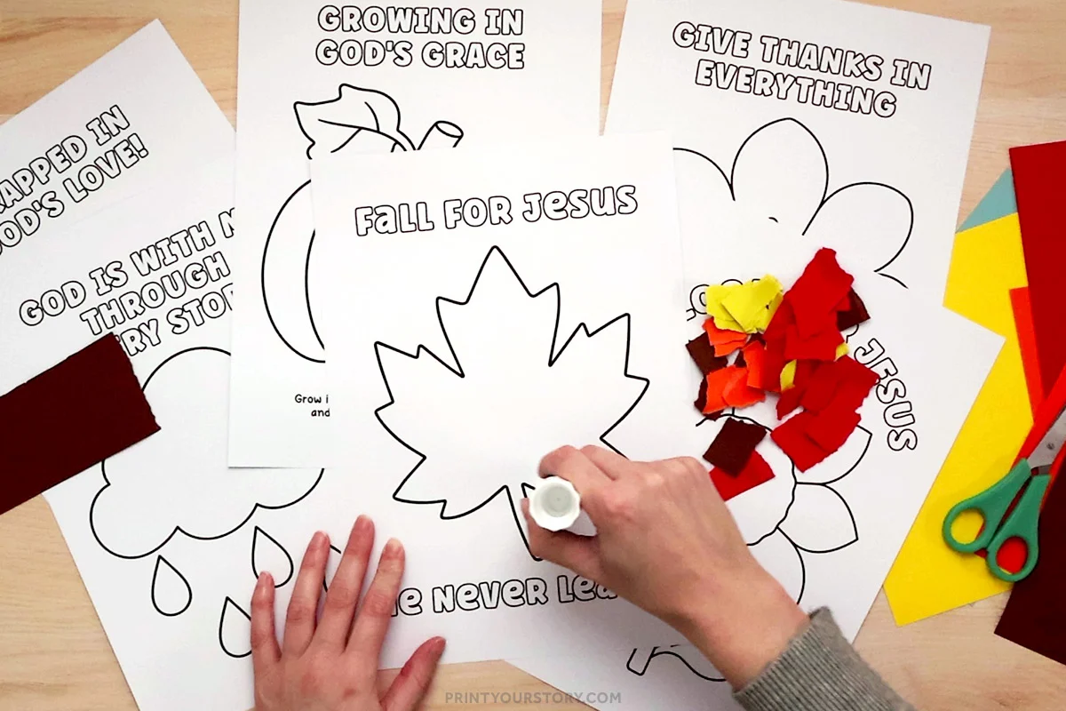 Hands gluing torn paper pieces onto a Christian fall leaf craft printable with scissors and colored paper nearby