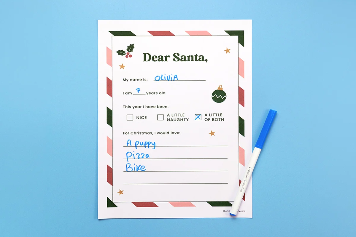 Filled-in Dear Santa printable letter worksheet with a blue marker on a light blue background