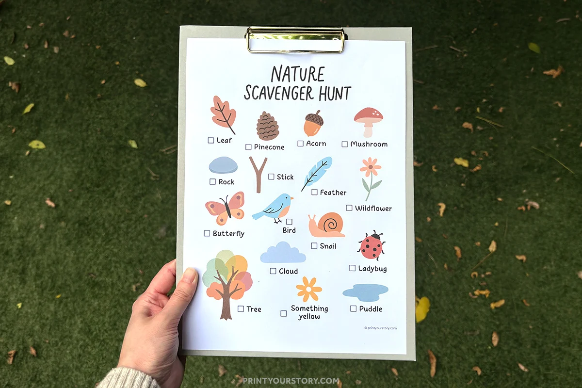 Nature scavenger hunt printable for kids on a clipboard outdoors with illustrated items and checkboxes