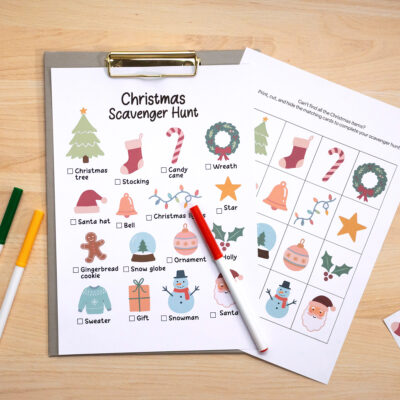 Christmas scavenger hunt printable worksheet with matching cards, marker, and crayons on a clipboard